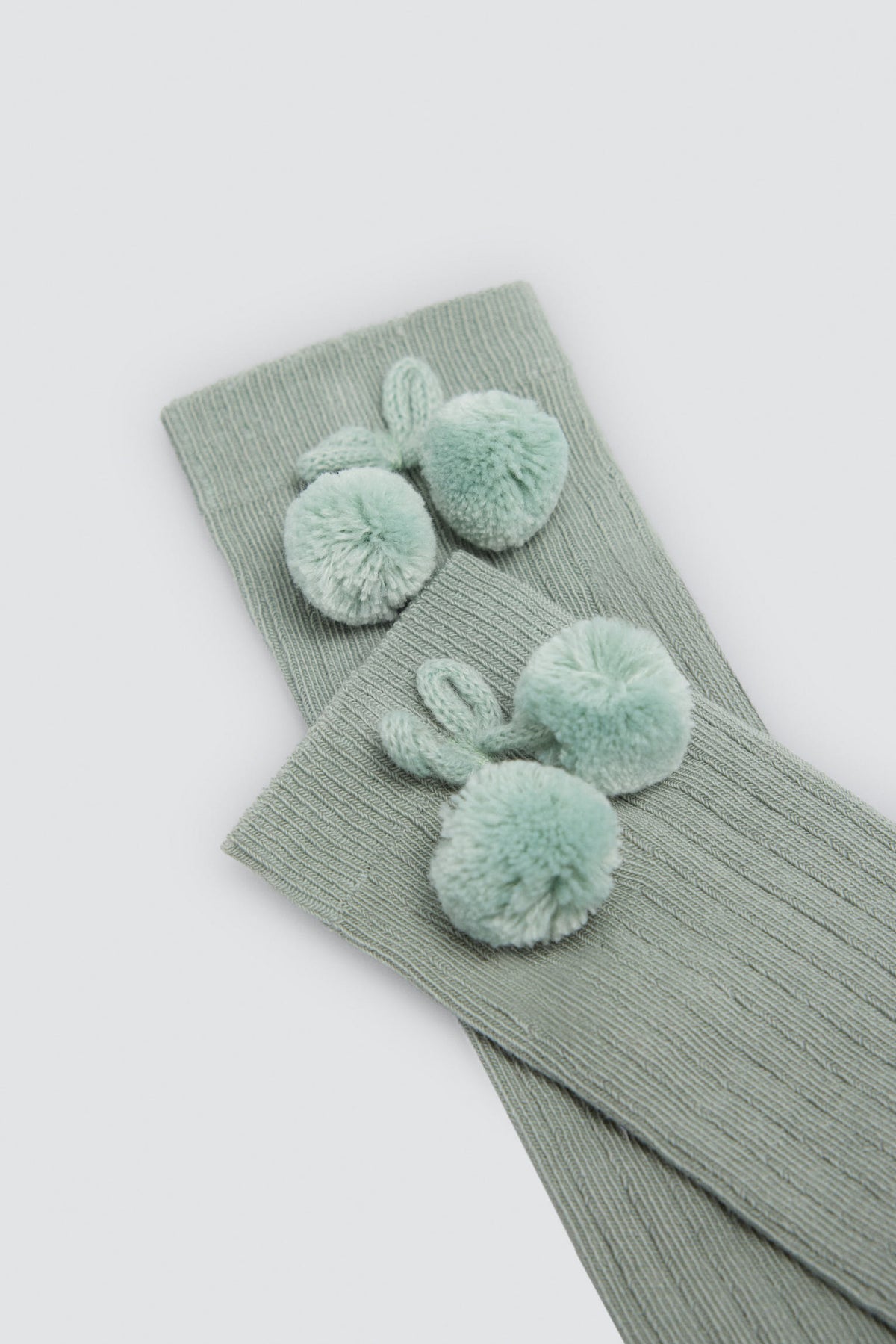 Chaussettes hautes enfant vertes détails pompons