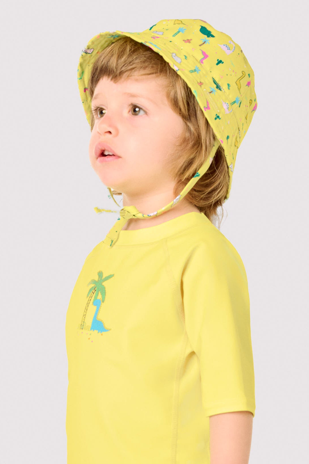 Gorro de playa bebé ala recta estampado dinosaurios - Ysabel Mora