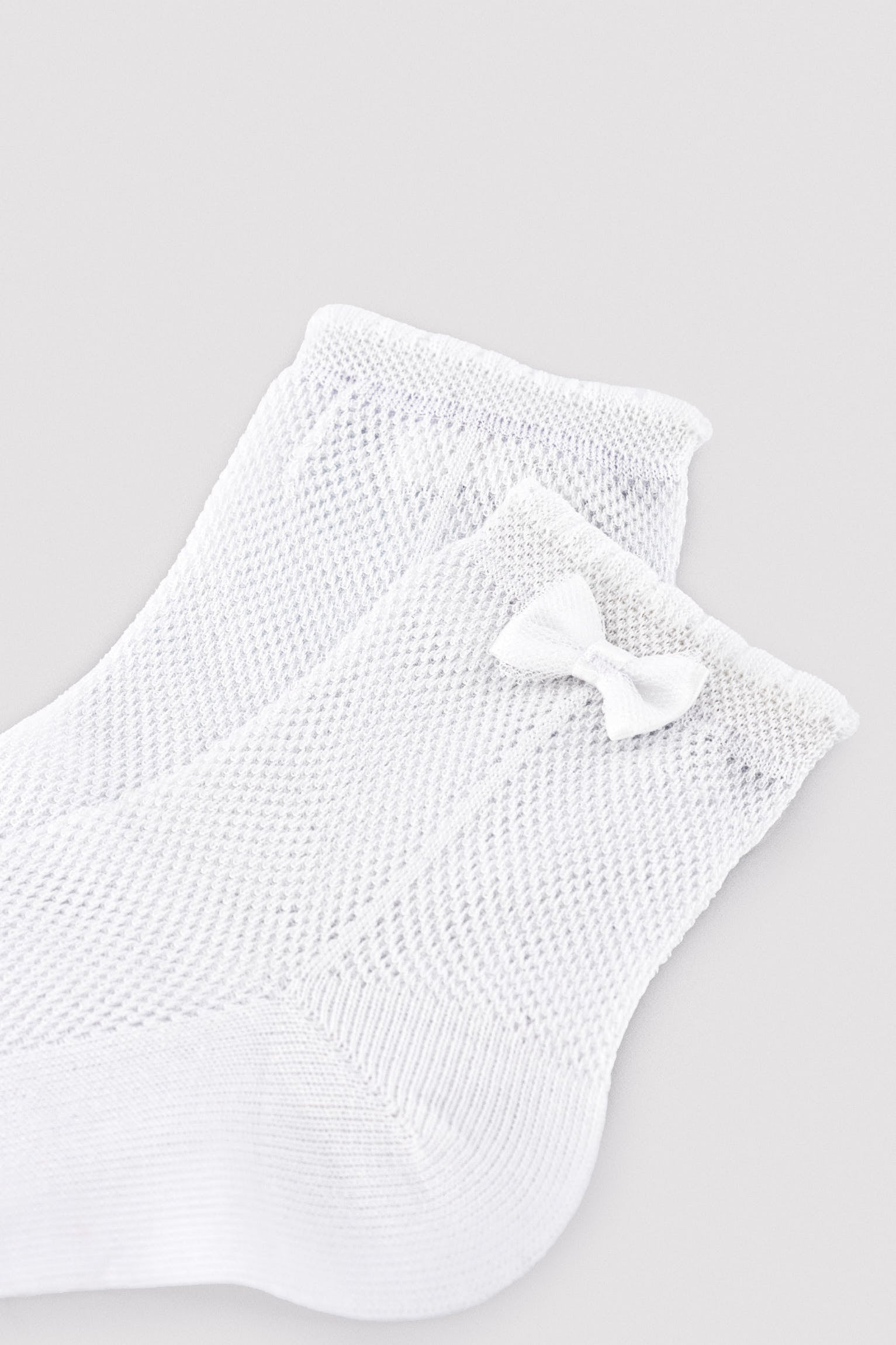Chaussettes ajourées pour enfants avec détail de nœud blanc